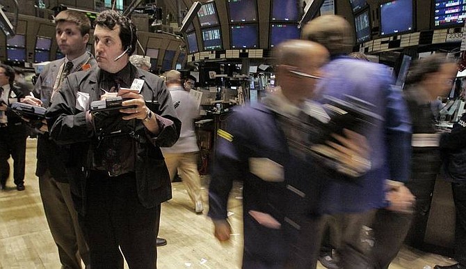 AP Photo/Richard DrewTrader Donato Vaccaro, second left, works on the floor of the New York Stock Exchange. Wall Street rebounded sharply Tuesday after the Federal Reserve and other central banks said they will pump $200 billion into the financial markets to help ease the strain from the credit crisis.