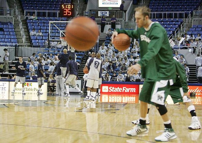 Photo by Brad HornHawai&#039;i&#039;s Matt Gibson warms up in the foreground while Nevada shoots before their game at Lawlor Events Center on Saturday.