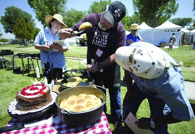 Amy Lisenbe/Nevada AppealJohn Fancher of Sutter Creek, Calif., center, lifts a beef wellington for judges, Dian Mayfield, left, and Omar Alvarez, right, to check that the dish is cooked properly Sunday afternoon during the Dutch Oven Cook-off at the Carson City Rendezvous. Fancher, along with his teammate Bridget Ebert of Glencoe, Calif., qualified to compete in the 2009 International Dutch Oven Society World Championship Cook-off, with a first place in the three-pot competition Sunday.