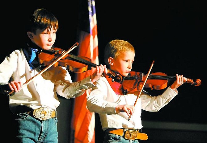 BRAD HORN/Nevada Appeal Connor and Tobin McCrae play the national anthem at the start of the Cowboy Jubilee at the Carson City Community Center on Saturday.