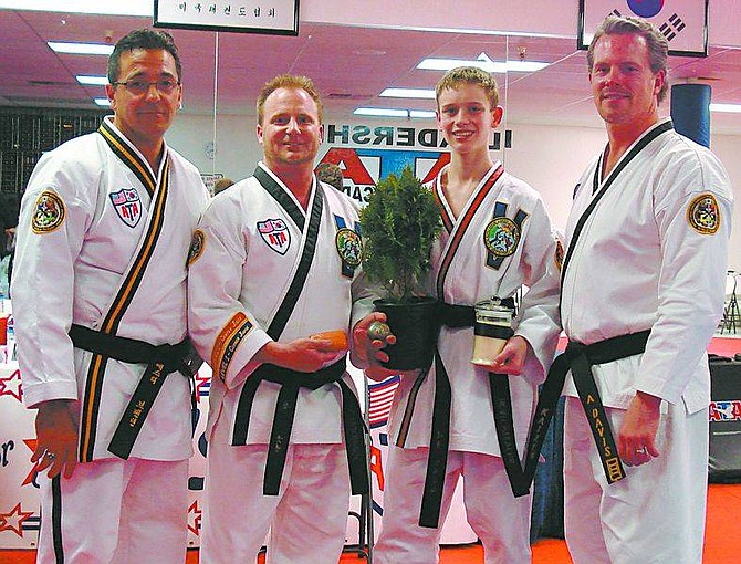Submitted photoBeau Stevens, 16, second from right, stands with his judges Friday night after being awarded the black belt at Carson ATA Blackbelt Academy. It was the first black belt the academy has awarded.