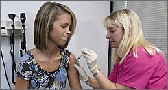 AP Photo/John AmisLauren Fant, left, 18, winces as she has her third and final application of the HPV vaccine administered by nurse Stephanie Pearson Dec. 18 2007, in Marietta, Ga. The vaccine helps prevent cervical cancer in girls by blocking the HPV virus, which researches found is by far the most common sexually transmitted infection in teen girls.