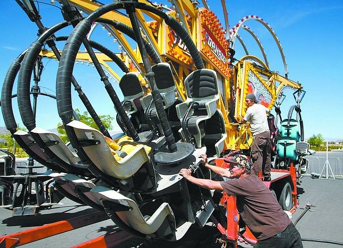 Cathleen Allison/Nevada AppealWorkers from the American Traveling Shows Inc. set up the &quot;Tornado&quot; ride Wednesday morning in Dayton. The carnival will run today through Sunday at the Dayton Valley Golf and Country Club as part of the Weekend Extravaganza fundraiser.