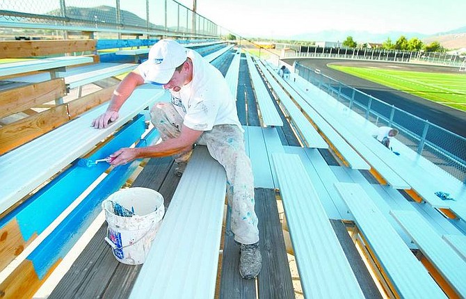 Cathleen Allison/Nevada AppealPaul Tim and a painting crew from Sunridge Painting, of Minden, puts the finishing touches on the bleachers at the Carson High School stadium Thursday morning. The $2 million project to renovate the facility, including a new track and FieldTurf football field, will be unveiled tonight when the Senators play their season opener against Spanish Springs at 7 p.m.