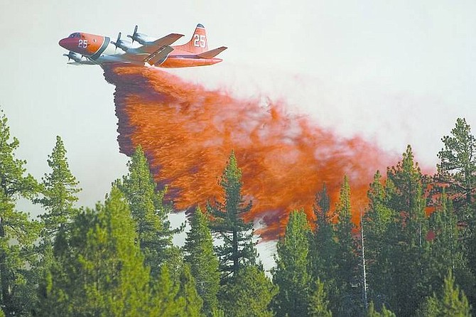 Jonah M. Kessel /Nevada Appeal News ServiceAn aircrfaft drops fire retardant on the Burnside fire in Hope Valley. Several Hope Valley businesses and homes are being threatened by the 100-acre fire along Blue Lakes Road about a mile south of Highway 88 in Alpine County south of Lake Tahoe, Calif.