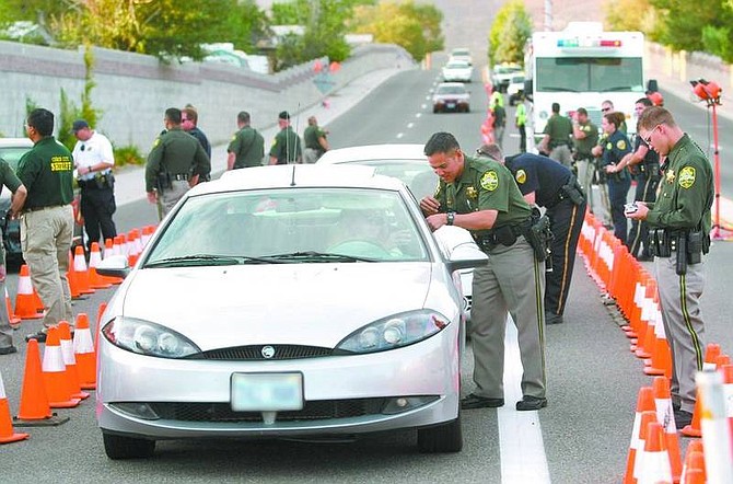Cathleen Allison/Nevada AppealCarson City Sheriff&#039;s Deputies talk with drivers stopped in a DUI checkpoint on College Parkway at Sherman Drive on Friday night.