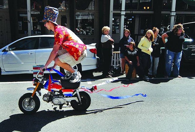Kevin Clifford/Nevada AppealMatt Potts of Reno rides a mini-motorcycle doing tricks and handing out candy during Virginia City Labor Day Parade on Monday.