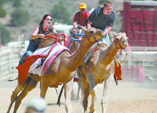 Cathleen Allison/Nevada AppealWhitney Shannon and Matt Rogers race in the Virginia City International Camel Races on Friday afternoon. The camel races continue today and Sunday.