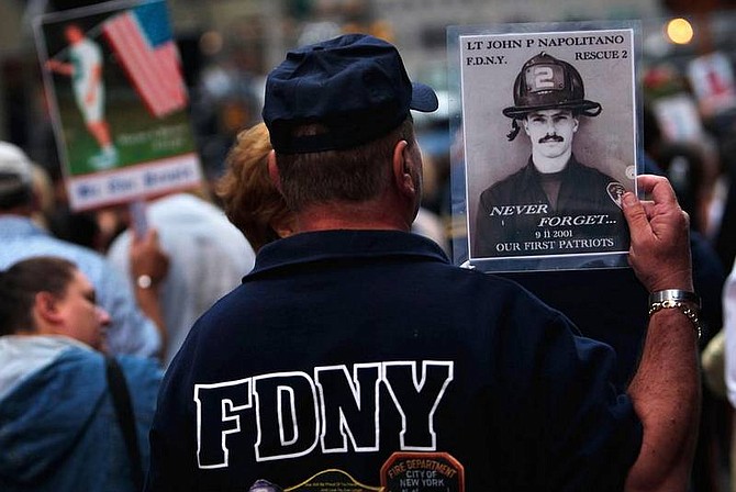 AP Photo/Chris HondrosA mourner holds a picture of a victim of the Sept. 11 terrorist attacks before the start of a memorial ceremony Thursday, Sept. 11, 2008 in New York. Throngs of family members of victims and others gathered in lower Manhattan for the annual ceremony.