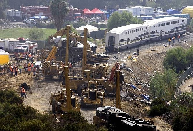 AP Photo/ Hector MataFirefighters continue to work on the wreckage of a Metrolink commuter train, Saturday, Sept. 13, 2008 in Chatsworth, Calif. Emergency crews found more victims early Saturday in the mangled wreckage of a commuter train that smashed head-on into a freight train, raising the death toll to 24 in the deadliest U.S. passenger train accident in 15 years.