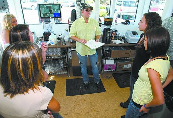Cathleen Allison/Nevada AppealJava Girls company president Steve McDaniel, of Seattle, talks with a group of employees at the new coffee shop in Carson City on Tuesday.