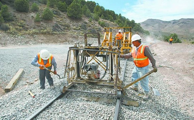 Cathleen Allison/Nevada Appeal A crew from H&amp;H Engineering Construction Inc. works Thursday raising and tamping the rail along the V&amp;T Railway near tunnel 2. Officials say this 4.5-mile section is scheduled to be done in about a month.