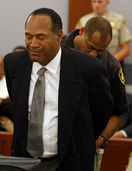 O.J. Simpson is taken into custody after being found guilty on all 12 charges, including felony kidnapping, armed robbery and conspiracy at the Clark County Regional Justice Center  in Las Vegas on Friday, Oct. 3, 2008. The verdict comes thirteen years to the day after he was acquitted of double murder charges.  (AP Photo/Daniel Gluskoter, Pool)