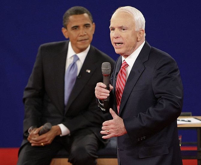 Republican presidential candidate Sen. John McCain, R-Ariz., right, speaks as Democratic presidential candidate Sen. Barack Obama, D-Ill., listens during a townhall-style presidential debate at Belmont University in Nashville, Tenn., Tuesday, Oct. 7, 2008. (AP Photo/J. Scott Applewhite)