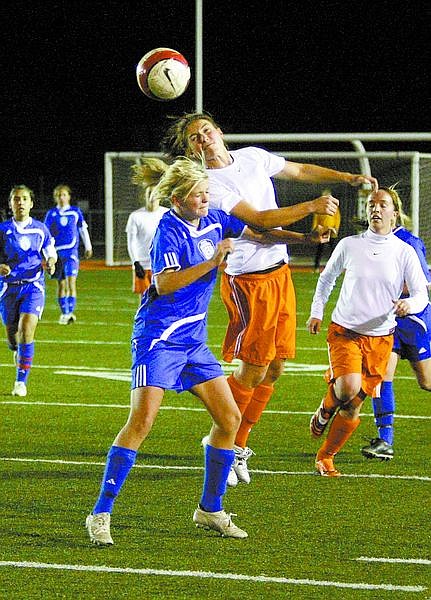 shannon Litz/Nevada Appeal News ServiceEmily Field of Carson and Mackenzie Cauley of Douglas battle for the ball on Tuesday night at Douglas.