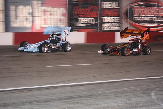 Rhonda Costa/Nevada AppealTroy Regier, driving the No. 98, makes and outside pass on Brian Warf of Boise, Idaho Saturday for the lead in the 50-lap main event. Regier went on to win the race, his 75th career win, at The Bullring at Las Vegas Motor Speedway.