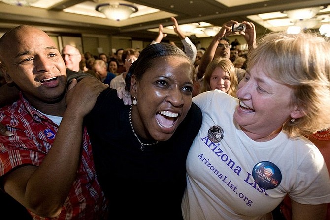 Steven Knight, left, Sherry Garrett and Beth Orrick, right, celebrate with supporters as they see CNN call the presidential election in favor of Sen. Barack Obama at the Arizona Democratic Party&#039;s election night celebration in Phoenix, Ariz., Tuesday, Nov. 4, 2008. (AP Photo/Aaron J. Latham)