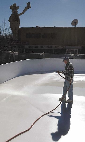 Cathleen Allison/Nevada AppealDon Mosher, with Ice RInk Events, sprays down the new Arlington Square Ice Rink in downtown Carson City on Tuesday. The rink is set to open Thursday as part of the annual Silver &amp; Snowflakes Festival of Lights.