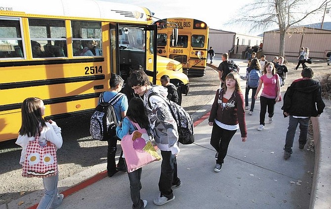 Cathleen Allison/Nevada AppealEagle Valley Middle School students scramble to get on buses Wednesday afternoon. While in better financial shape than many other districts, Carson City School District officials continue to evaluate ways to save money.