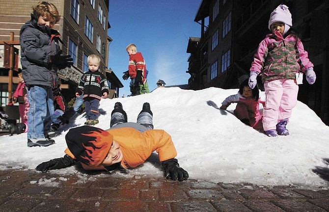 Emma Garrard/Nevada Appeal News ServiceEthan Wo, 8, slides down a pile of snow at the Village-at-Northstar on Friday. Although there was no skiing, the village still had traffic for the Thanksgiving weekend.