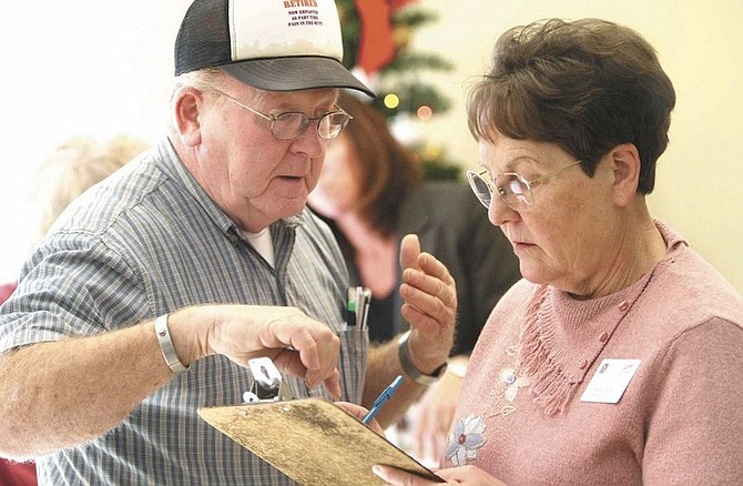 Cathleen Allison/Nevada AppealRenate Daniels, a Medicare S.H.I.P. volunteer, talks with Jerry Welch on Tuesday during an event at the Carson CIty Senior Citizen Center to help seniors navagate the Medicare and Medicade programs.