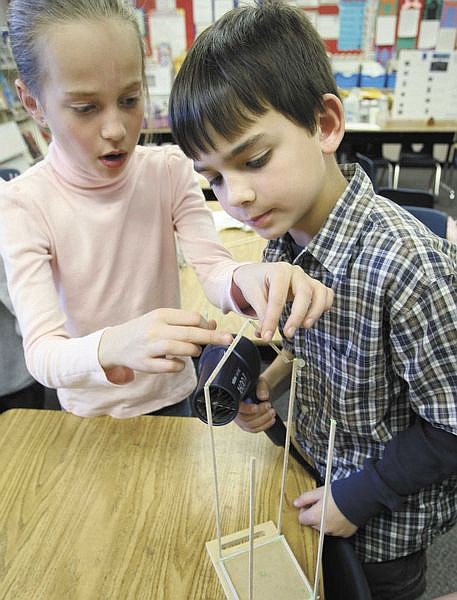 Cathleen Allison/Nevada AppealAlexa Conrad, 8, and Alex Marschner, 9, work on a structure Wednesday built of balsa wood and glue. The Bordewich-Bray Elementary gifted and talented students were trying to create structures that would withstand a simulated earthquake.