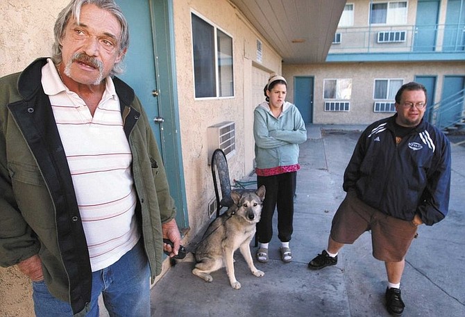 Cathleen Allison/Nevada AppealFrontier Motel residents, from left, Ronnie Hunter, Krystal and Scott Bruce talk Wednesday about the upcoming foreclosure of the motel. Hunter says he&#039;s concerned that since no other motels in town will allow his wolf, Loshee, it&#039;s possible &quot;I&#039;ll be sleeping on the streets.&quot;