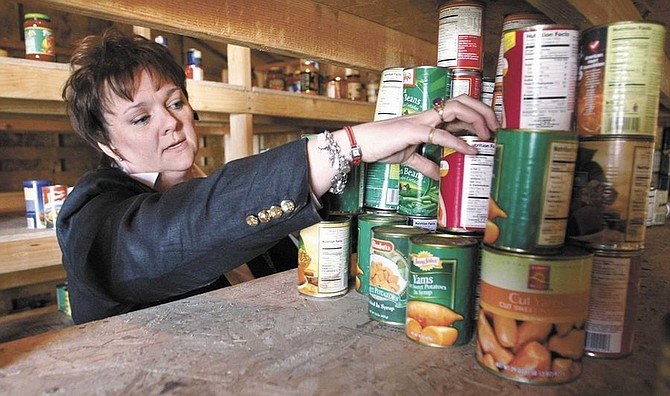 Cathleen Allison/Nevada AppealLisa Lee, director of Advocates to End Domestic Violence, looks through some of the canned food stored at the shelter Wednesday. The annual Share Your Holiday food drive will be held Friday from 6 a.m. to 6 p.m. at the Governor&#039;s Mansion.