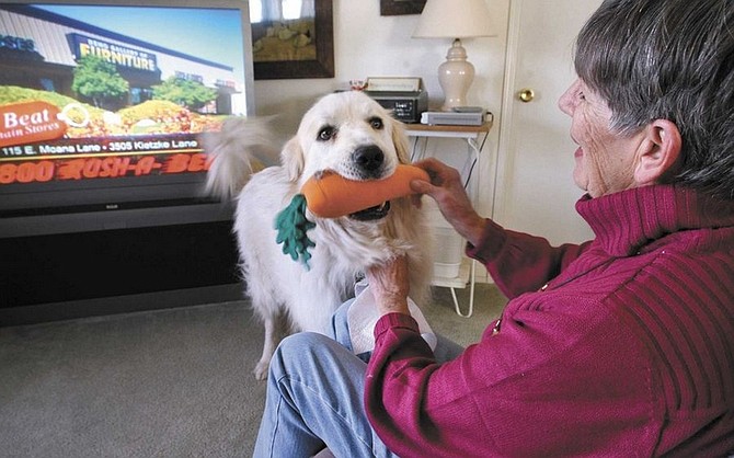 Cathleen Allison/Nevada AppealVirginia Johnson plays with her dog Gunner in her Silver Springs home Thursday. Johnson still uses an antenna to receive Reno TV channels and will be impacted by the digital TV conversion.
