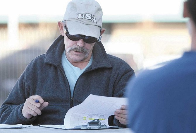 Cathleen Allison/Nevada AppealWayne Johnson tries to auction a number of properties Thursday afternoon in front of the Carson City Courthouse. The Frontier Motel was foreclosed and taken over by Excel National Bank after no one bid on it.