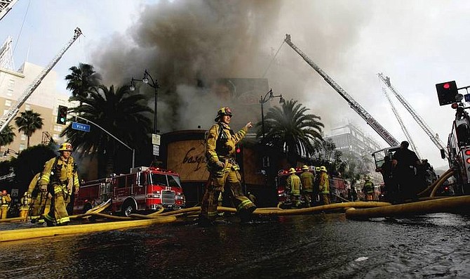 AP Photo/Nick UtFirefighters work the site of a fire in the Hollywood section of Los Angeles, Wednesday, April 30, 2008. The fire in a storied building at Hollywood and Vine spit flames 40 feet into the air and burned close to landmarks such as the Capitol Records building and the Pantages Theater.