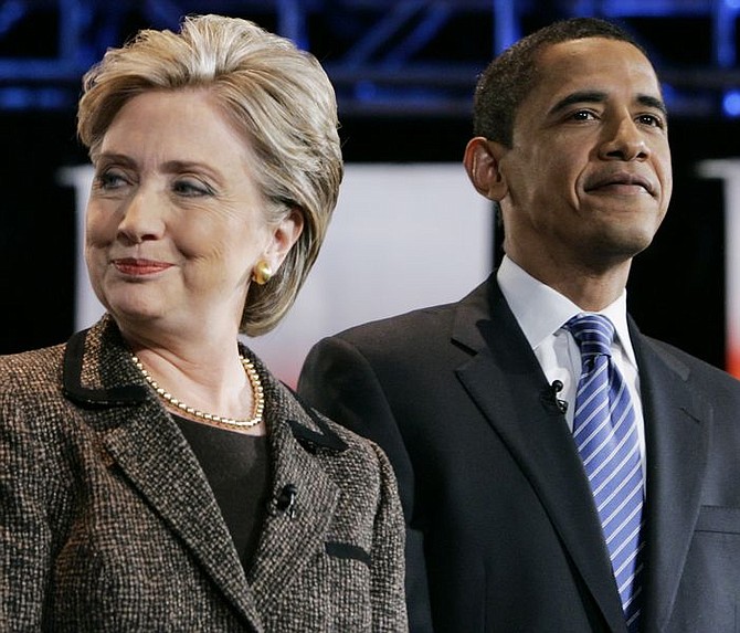 ** FILE ** Democratic presidential hopeful, Sen. Hillary Rodham Clinton, D-N.Y., left and  Democratic presidential hopeful, Sen. Barack Obama, D-Ill., arrive on stage for a debate at Cleveland State University in Cleveland, in this Feb. 26, 2008, file photo. (AP Photo/Carolyn Kaster, file)