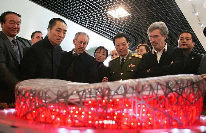 AP Photos/Color China PhotoHollywood director Steven Spielberg, third from left, looks at a model of Beijing&#039;s National Stadium with Chinese film maker Zhang Yimou, second from left, and Jiang Xiaoyu, executive vice president of the Beijing Olympics organizing committee, left, after a news conference announcing the creation team for the opening and closing ceremonies of the 2008 Olympic Games in Beijing April 16, 2006. Spielberg announced Wednesday that he would shun involvement with the Beijing Olympics opening and closing ceremonies because China was not doing enough to help end the crisis in Darfur.
