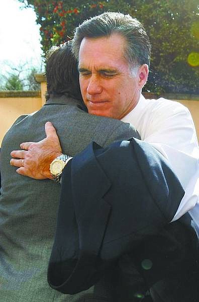 Gerald Herbert/Associated Press Republican presidential hopeful and former Massachusetts Gov. Mitt Romney hugs a supporter as he leaves the back entrance of the Omni Shoreham Hotel after pulling out of the presidential race in Washington on Thursday.