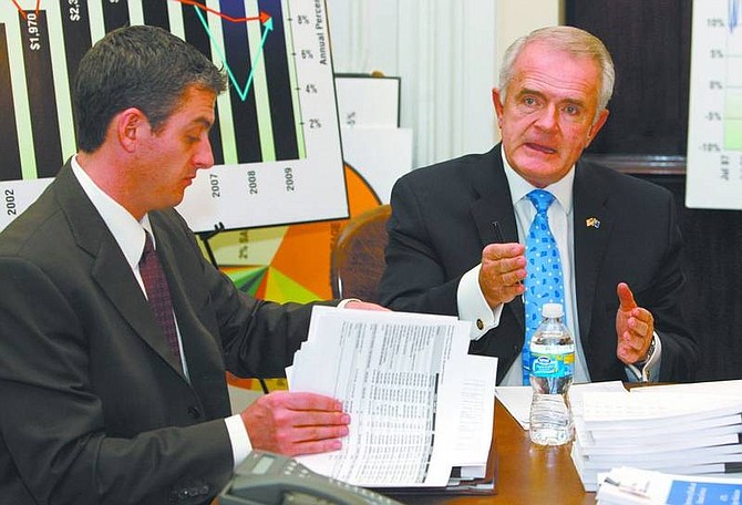 Cathleen Allison/Nevada Appeal Nevada Gov. Jim Gibbons, right, and state budget director Andrew Clinger answer media questions Friday at the Capitol in Carson City.