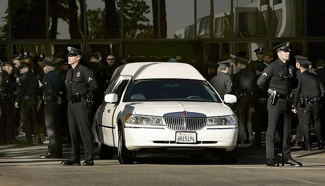 AP Photo/Al SeibA hearse carrying the body of slain SWAT team member Randal Simmons, killed in a raid on a gunman&#039;s house Feb. 7, arrives at the Crenshaw Center Faith Dome Friday in Los Angeles. Simmons was the LAPD&#039;s first SWAT officer to die in the line of duty since the unit was formed in 1967. He had been with the elite unit for 20 years and was the group&#039;s second-highest ranking member.