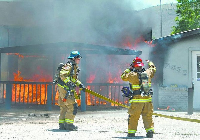 Cathleen Allison/Nevada Appeal Fire damaged an abandoned building on Highway 50 East near Lompa Lane on Wednesday afternoon.