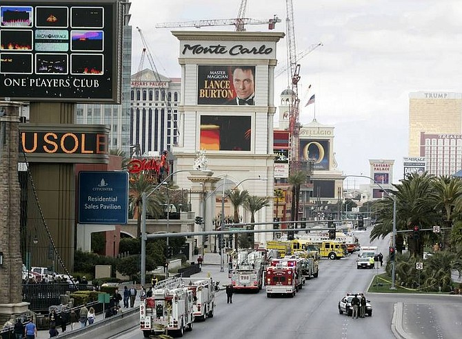 Ronda Churchill/Las Vegas Review-Journal/Associated Press Emergency crews are shown on Las Vegas Boulevard South outside the Monte Carlo hotel-casino Friday in Las Vegas. A fire on the roof of the 32-story Monte Carlo hotel-casino forced guests and gamblers to flee and sent flaming debris raining down, but the blaze eased after about an hour and no serious injuries were reported.