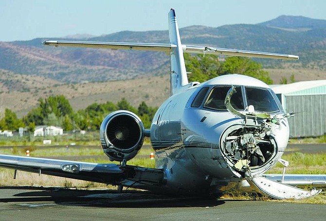 A charter jet rests on the tarmac at the Carson City Airport in August 2006 after a midair collision with a glider over the Pine Nut Mountains in August 2006. Citing the danger of midair collisions between gliders and airplanes, the National Transportation Safety Board recommended Tuesday that all gliders operated with transponders.  Nevada Appeal File Photo