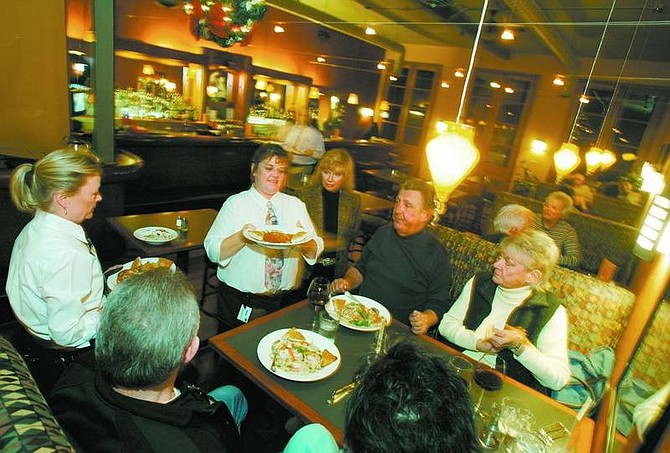 BRAD HORN/Nevada Appeal Dale and Madeleine Fox, of Dayton, center, are served pasta while J&#039;s&#039; Bistro partner Jackie Behan, watches at the new Italian restaurant in Dayton on Wednesday.