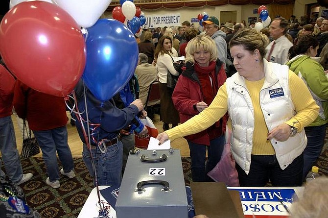 AP Photo/Will KincaidKaija Ford cast her ballot during the Republican Party presidential caucus in Bismarck, N.D., on Tuesday.