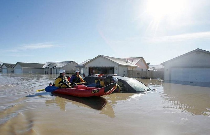 Reno HASTY team members investigate a flooded car in the Canary Circle area of Fernley, Nev., on Saturday, Jan. 5, 2008, after severe flooding devasted the area.