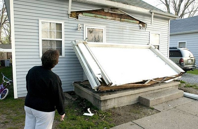 AP Photo/Daniel R. PatmoreJanet Clem, 37, looks at the damage to her home in Mt. Carmel, Ill. Friday morning April 18, 2008 after the 5.2 early morning earthquake.