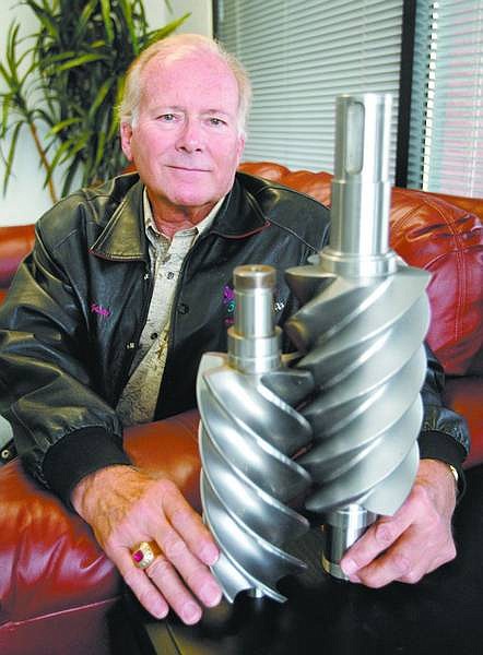 Cathleen Allison/Nevada Appeal Richard Langson, founder of ElectraTherm, displays an example of twin screws for the turbines in the units his company makes that capture excess industrial heat and use it to produce electricity.