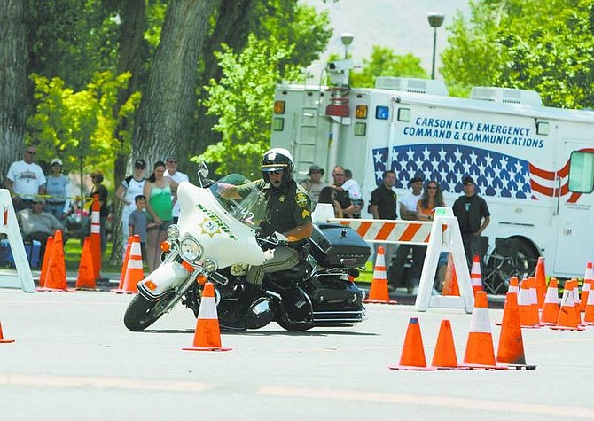 BRAD HORN/Nevada Appeal Carson City Sheriff&#039;s Department Sgt. Mike Cullen competes in the Extreme Motor Officer Training Challenge on Saturday at Mills Park.
