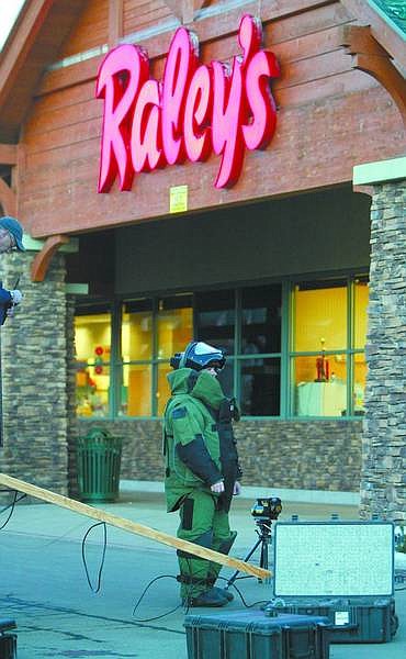 Jim Grant / Nevada Appeal News Service Todd Moss, a member of the Tahoe Douglas bomb squad, prepares to enter the Stateline-area Raley&#039;s early Monday evening after a bank robbery and bomb scare. A box that the robber said contained a bomb was rendered harmless by the squad.