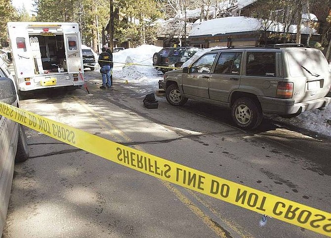 Dan Thrift / Nevada Appeal News Service South Lake Tahoe Police and El Dorado County Sheriff investigators at the scene of a shooting Saturday morning where a 21-year-old man was shot in the head. The victim, who has not been identified, was in critical condition as of Saturday night.