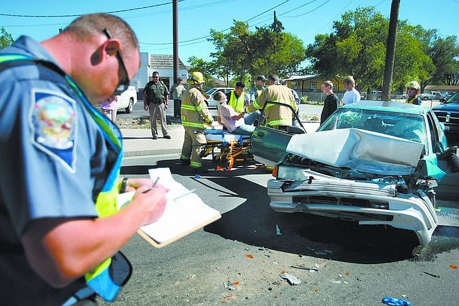 Cathleen Allison/Nevada Appeal A Carson City woman, suspected of drunken driving, was taken to Carson Tahoe Regional Medical Center by ambulance Wednesday afternoon following an accident at Highway 50 west of Airport Road.