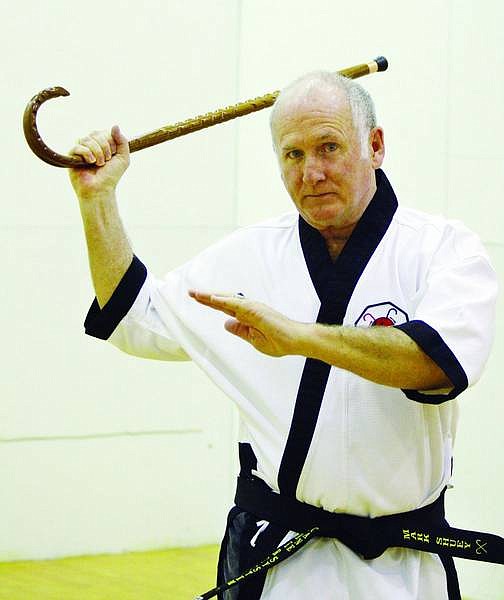 Jen Schmidt/Nevada Appeal News Service Incline Village resident and martial arts master Mark Shuey travels around the world teaching elderly and disabled people how to defend themselves using a cane.