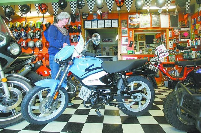 BRAD HORN/Nevada Appeal Diana Cranston, owner of DC Motor Sports, says that the Tomos Streetmate R is one of the more popular mopeds offered at her Carson City shop on Friday.
